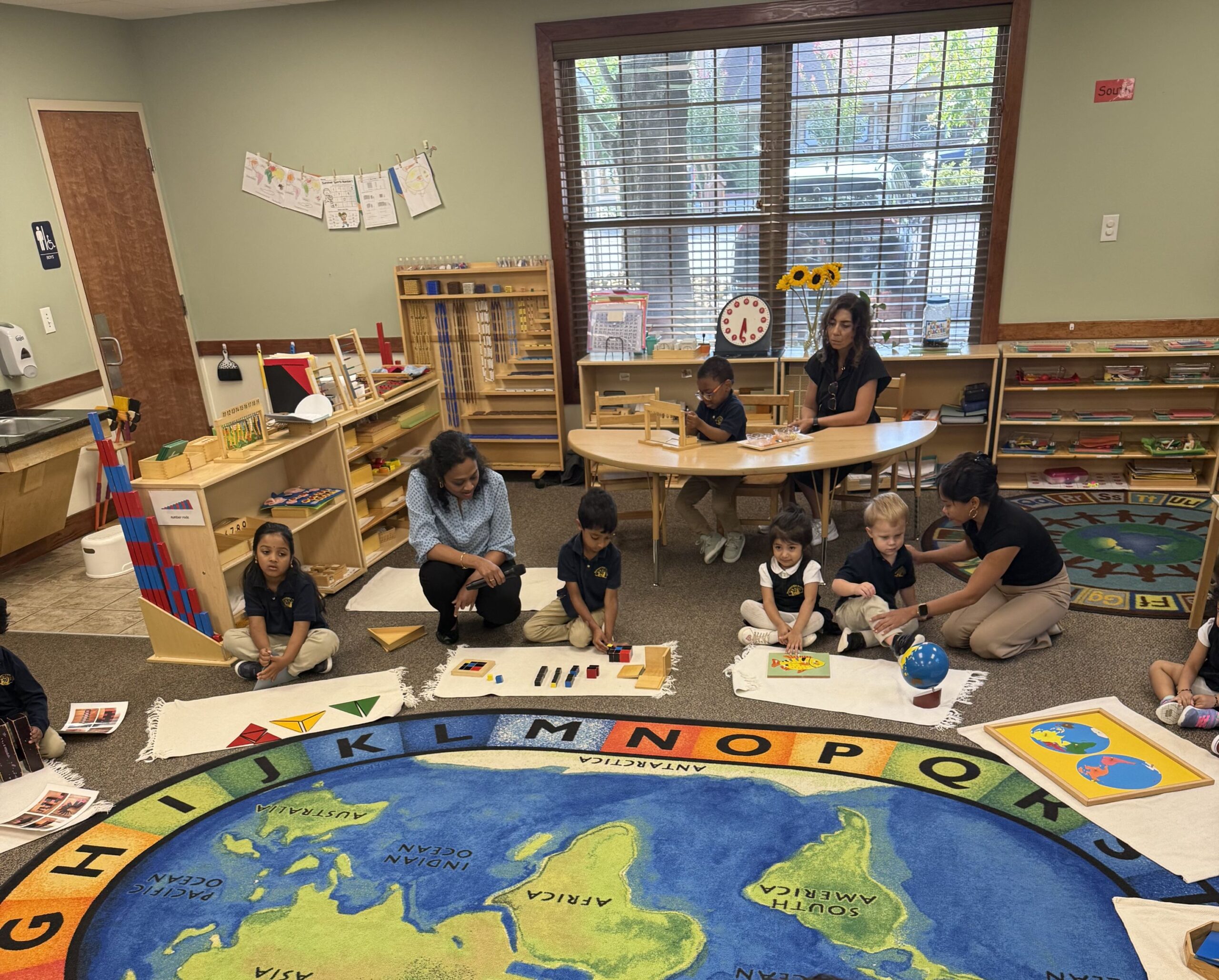 kids learning around world map rug