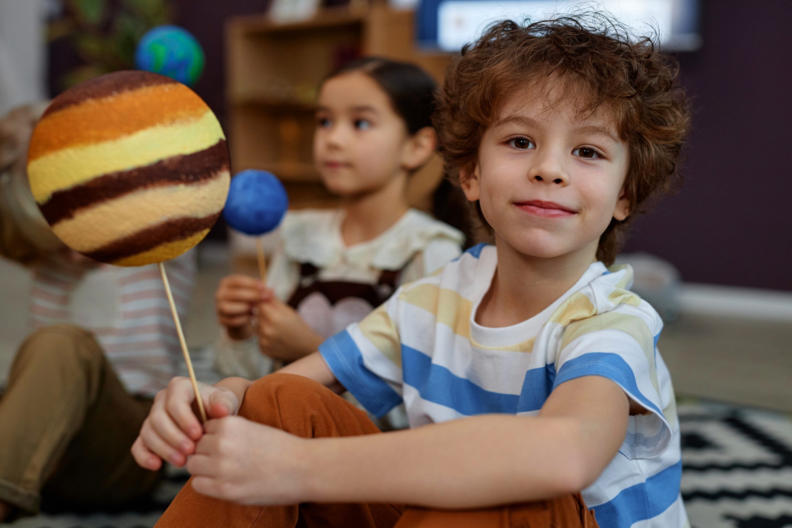 Portrait,Of,Cute,Little,Kid,Holding,Planet,Model,And,Smiling