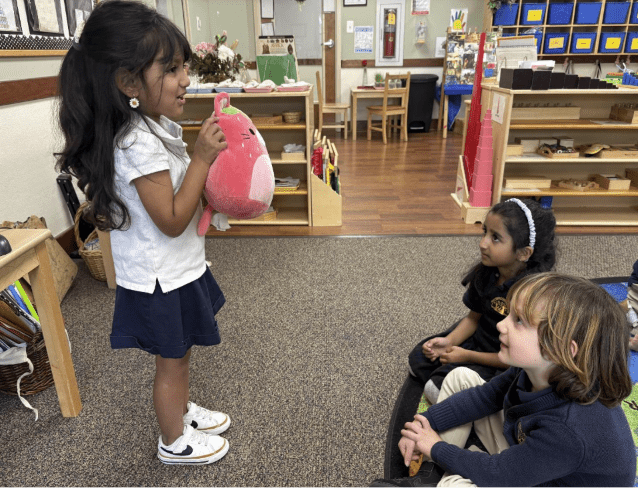 kid showing stuffed animal at Show and tell